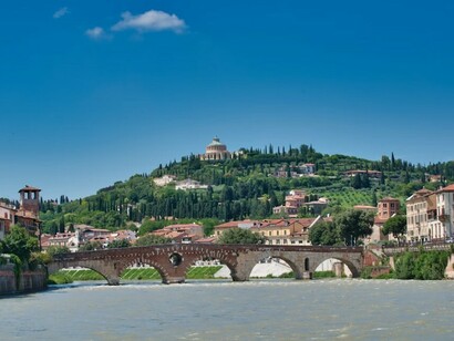 Historic bridges like Ponte Pietra cross the Adige and offer beautiful views of the surrounding landscape, Italy