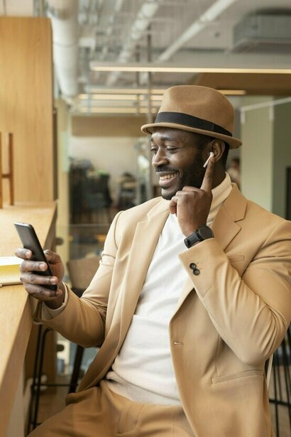 A well-dressed man working over coffee, representing the idea that confidence and competence often outweigh appearance over time
