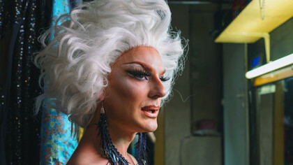 In the spotlight of creativity, the drag queen's eye makeup sparkles with bold colours, reflecting the vibrant spirit of self-expression that defines the art of drag