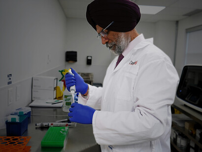 Bearded scientist working in a laboratory, examining medical research data with a focus on healthcare skepticism