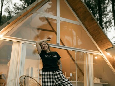 Serene mountain scenery surrounding a modern wooden A-frame cabin, reflecting a calm offline lifestyle focused on nature, mindfulness, and slow travel