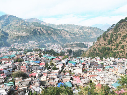 A picturesque scene of Himachal Pradesh, India, with its rolling hills, snow-capped peaks, and tranquil rivers, perfectly embodying the region's timeless charm and natural splendor