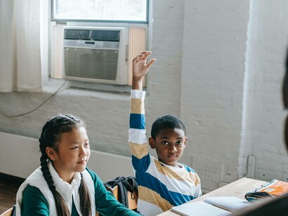 Student raises hand in Swahili class