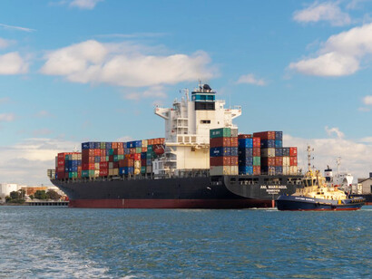Cargo ships at the pier, loaded with freight containers, representing global trade dynamics, strategic alliances, and the growing significance of the India-Middle East-Europe Economic Corridor in economic diplomacy