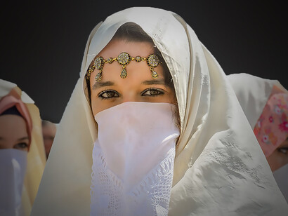 Algerian women wearing the haik, a traditional Maghrebi garment