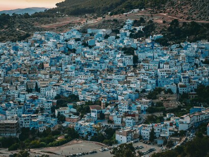 Chefchaouen’s tranquil blue streets set against the mountainous backdrop, reflecting the enduring identity of northern Morocco