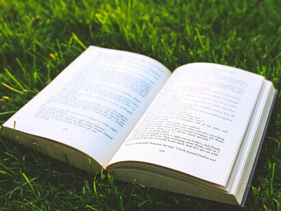 An open book on grass, showing how the tales passed down through the ages help us stay rooted in who we are