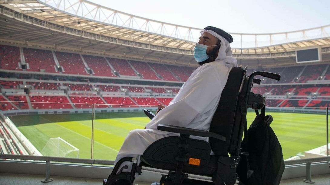 A handicap Arab gentleman in a football stadium waiting for the FIFA World Cup in Qatar to begin