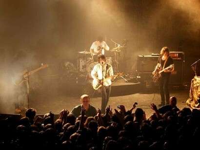 The Arctic Monkeys performing at a gig in the UK