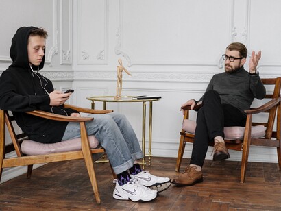 Teenager looks at phone during therapy