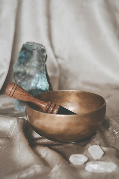 The brown wooden spoon gracefully rests upon the smooth surface of the round brown bowl