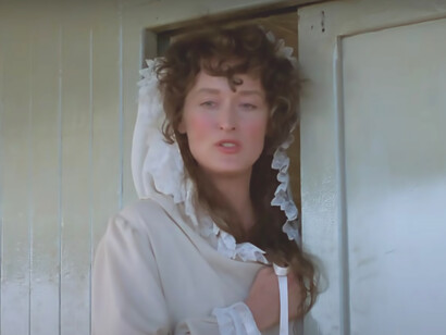 Meryl Streep's ethereal presence is captured in the white dress she wears in the film 'Out of Africa,' an exquisite portrayal that transcends the screen and leaves a lasting impression