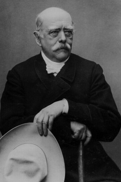Portrait of Otto von Bismarck, the first Chancellor of the German Empire, standing with a hat and walking stick. A dominant figure in 19th-century European politics, Bismarck played a central role in German unification and helped shape the continent's balance of power before World War I
