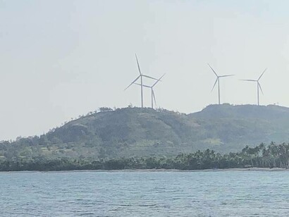 Caparispisan Wind mills churn in Saud Beach, Pagudpud, Philippines 