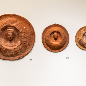 Terracotta calyx medallion with bust
1st – first half of 2nd c. AD
Thought to have been offered in lieu of actual flowers, or to have served some other ritual function.

