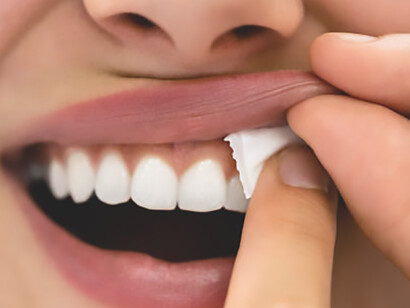 Image of a woman indulging in the sensory experience of chewing wet, moist nicotine tobacco snus, illustrating the nuanced nature of this form of tobacco consumption
