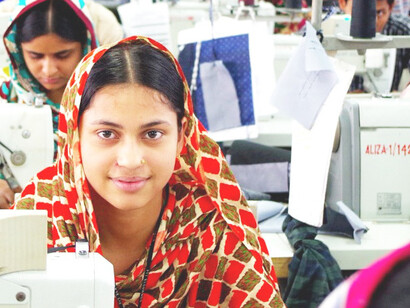 A garment worker carries out her duties on a production line in a Bangladeshi clothing factory, photo by 
International Labour Organization 