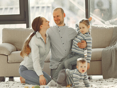 Happy family having fun in the living room at home, showing parent–child interaction