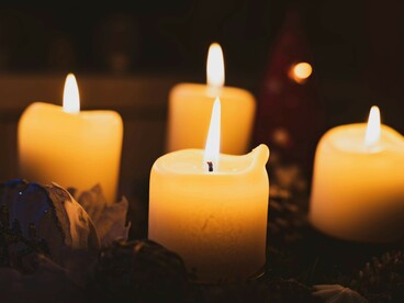 A single flame flickers in warm candlelight, guiding the path forward
