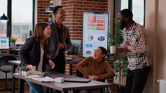 In an open office space, colleagues work together on a shared digital platform, reflecting how AI is transforming the way teams collaborate remotely, from anywhere in the world
