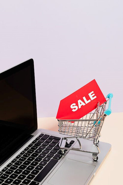 An illustrative depiction of a trolley displayed on a laptop with sale banner