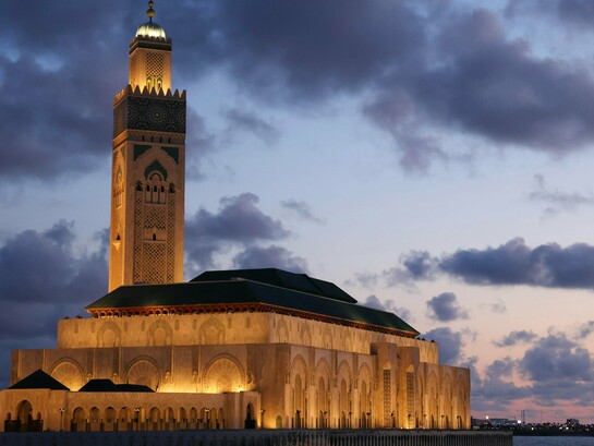 The Hassan II Mosque towering over Casablanca at sunset, showing Morocco’s balance of tradition and modern identity
