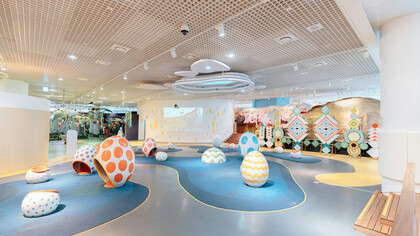 Interior of a modern pediatric ward with colorful seating, designed to create a welcoming and family-friendly environment for young patients