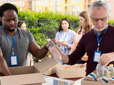 Volunteers working together at a local food bank, demonstrating the power of kindness and community support