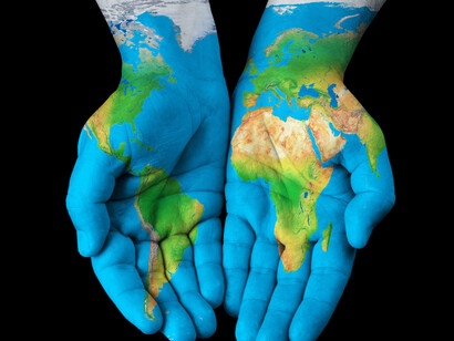 Painted hands, globe