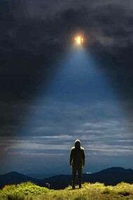 A man looks to the light in the sky