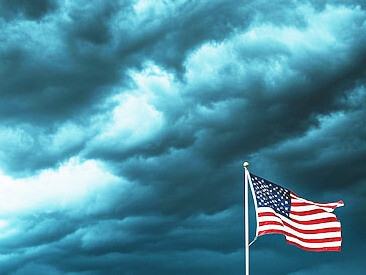 As the American flag flutters against a stormy sky, the winds of change stir uncertainty across the nation, with Trump’s victory in 2024, the country braces for a tumultuous, unpredictable future