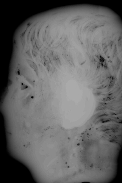 X-ray photograph showing minor impurities in the metal and the outlines of square repair patches. © The Trustees of the British Museum