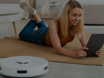 Experience the convenience of a person using a robot vacuum cleaner at home, effortlessly maintaining a clean living space with cutting-edge technology