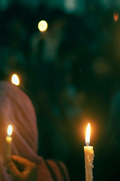 People hold candles together