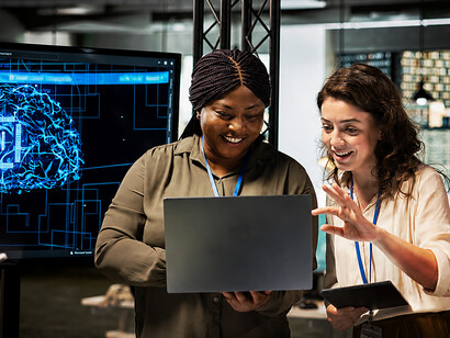 Employees collaborating with AI-powered tools and cloud-based systems in a professional office environment