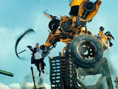 Bumblebee transforms mid-action while Sam Witwicky is sent flying, representing Bay’s instinct for turning chaos into choreography in Transformers: Dark of the Moon (2011)