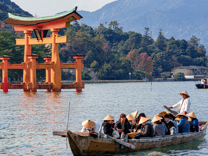The tranquil beauty of Hiroshima's Itsukushima Shrine, located on Miyajima Island, with a view of the scenic 1-1 Miyajimacho in Hatsukaichi, Japan, blending cultural heritage and serene landscapes