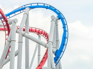 A colourful amusement ride twisting against the clouds, reflecting the spectacle of an event remarkable enough to earn its own Tiranos Temblad episode