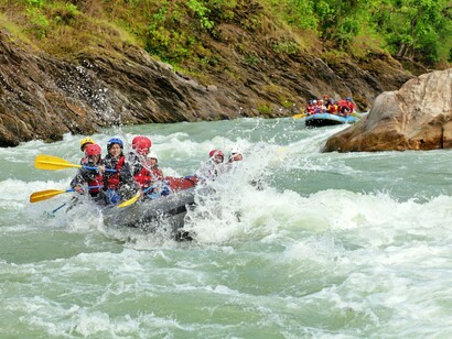 A group of adventurers rafting down the Trishuli River in Nepal
