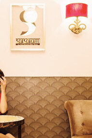 A woman drinking coffee in a cafe in Rome, Italy