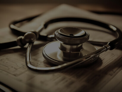 In the forefront, a medical instrument stands on paperwork, symbolizing the vital link between meticulous documentation and essential healthcare tools