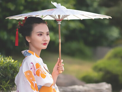 Beauty of Japanese culture as a woman exudes elegance in a traditional kimono, complemented by the iconic Wagasa umbrella
