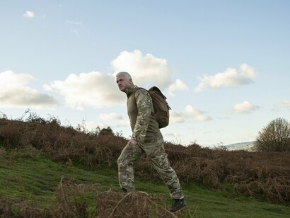 Neither chased nor triumphant, the lone figure embodies the quiet burden of past interventions and future recalibration