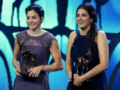 Syrian refugee swimmers Yusra and Sarah Mardini (from left) receive the Silent Heroes Award during the Bambi 2016 media awards ceremony in Berlin, Germany