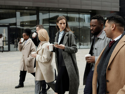 Coworkers walking during a coffee break, illustrating a diverse team