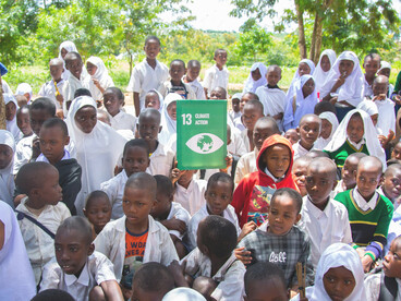 A group of children participating in a community-led climate action initiative in a rural environment