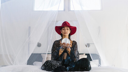 Woman meditating holding a crystal ball