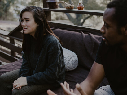 A woman looking distressed as her husband argues