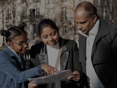 Expat family examining a map to navigate their new city, illustrating their journey and adaptation challenges