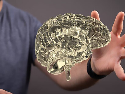 A captivating close-up reveals the intricate details of a 3D-rendered brain, while alongside it, a man delicately extends his hand, making tactile connection with the neural imagery